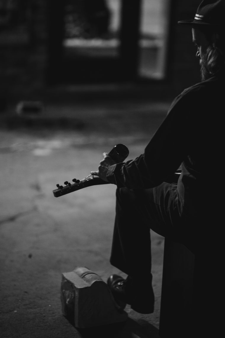 Mark Lavengood seated with his resonator guitar